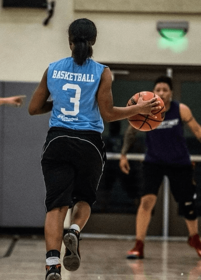 A cornhole tournament with players tossing bags on a sunny afternoon